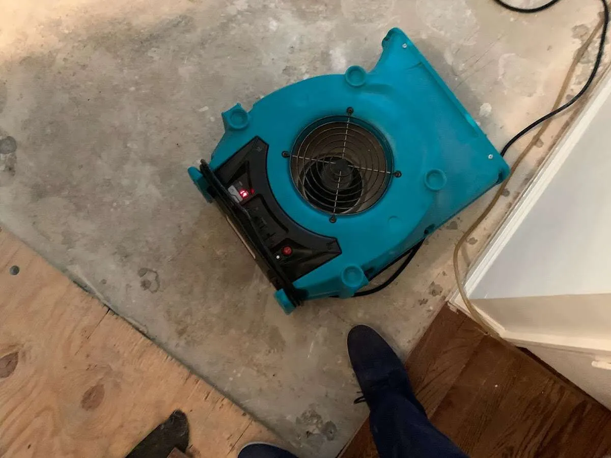 Air mover drying subfloor during Leak Detection & Repair in Ishpeming